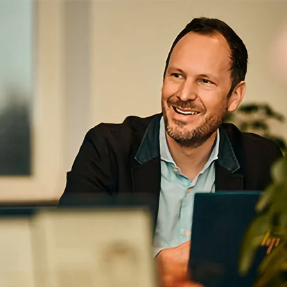 Laughing man in a suit at a table Laughing man in a suit at a table