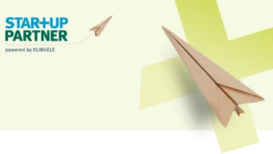 Two paper planes against a light yellow background 