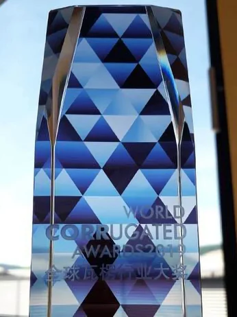 a glass trophy with a blue and white design with the inscription: World Corrugated Award 2021